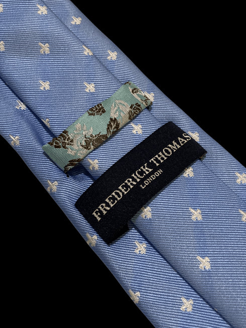 light blue tie with fleur de lis pattern
